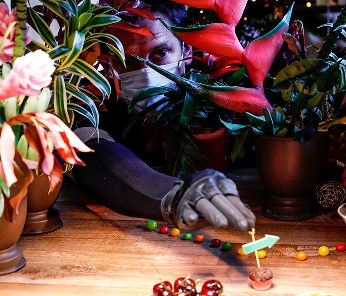 A hand is reaching for a green arrow on a table