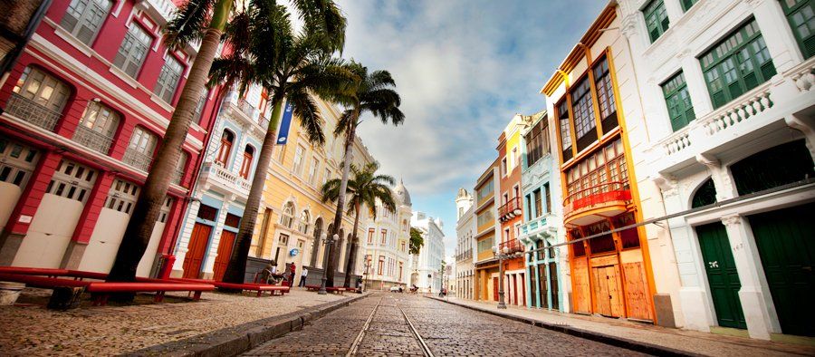 Bom Jesus street in Recife A row of colorful buildings are lined up on a cobblestone street.