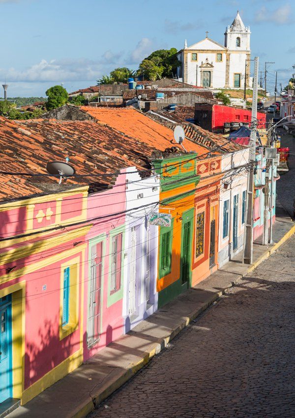 Centro Histórico in Olinda A row of colorful houses with a church in the background.