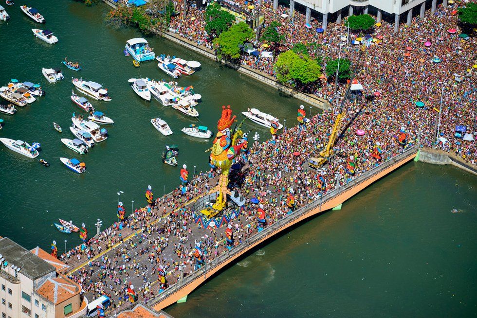 An aerial view of a bridge filled with people and boats