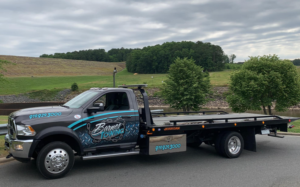 A tow truck is parked on the side of the road.