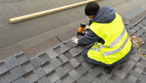 Construction Worker Installing Asphalt Roof | Green Bay, WI | Machkovich Roofing LLC