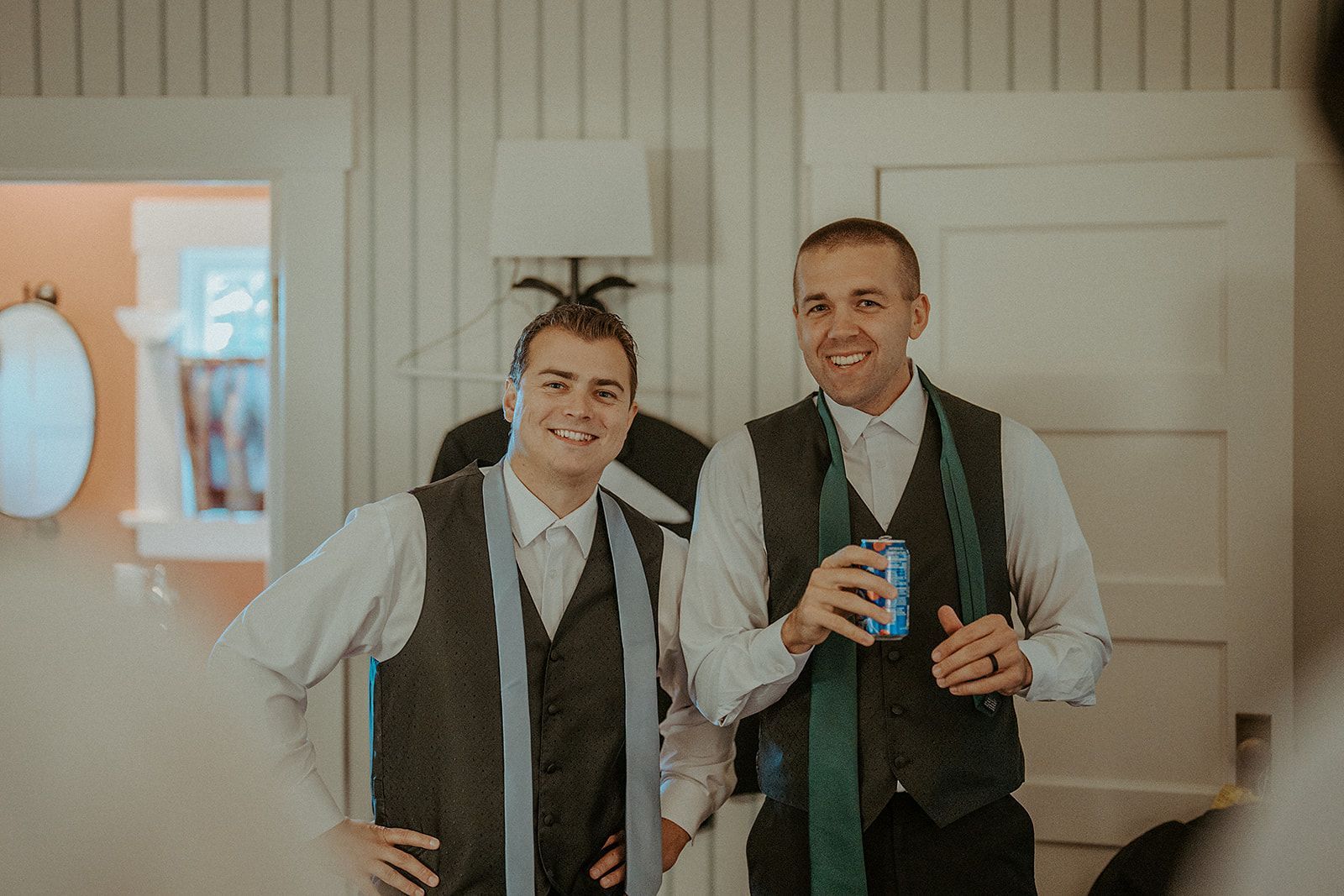 Two men in suits are standing next to each other in a room.