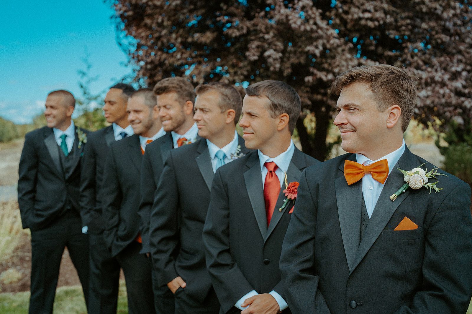 A group of men in suits and bow ties are standing next to each other.