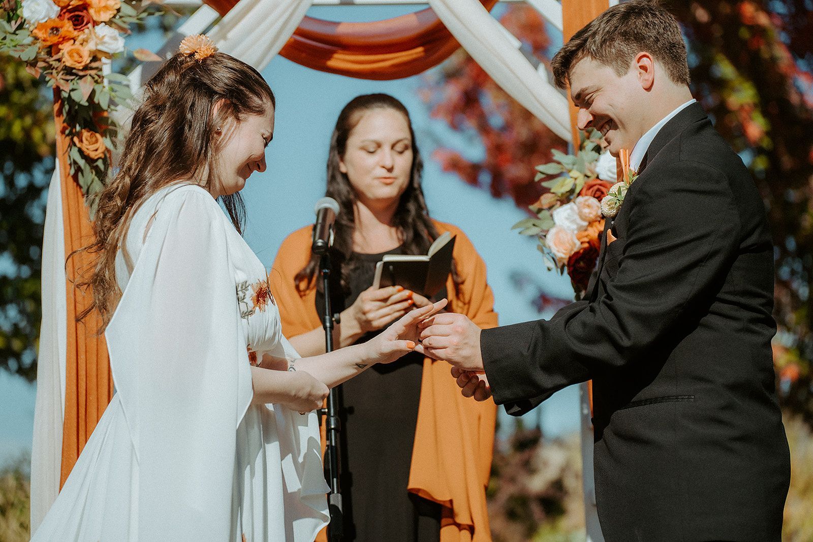 A bride and groom are getting married at a wedding ceremony.