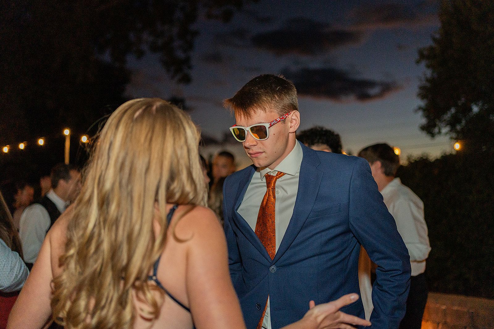 A man in a suit and tie is dancing with a woman.