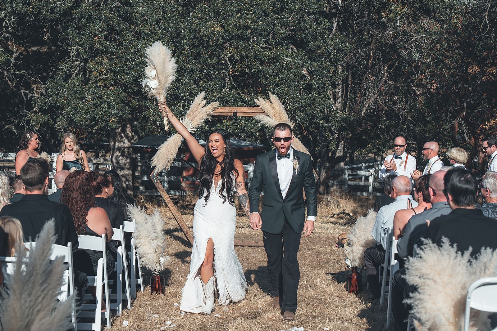 A bride and groom are walking down the aisle at their wedding.