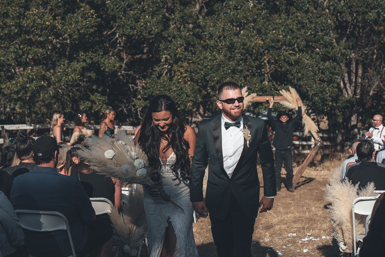 A bride and groom are walking down the aisle at their wedding.