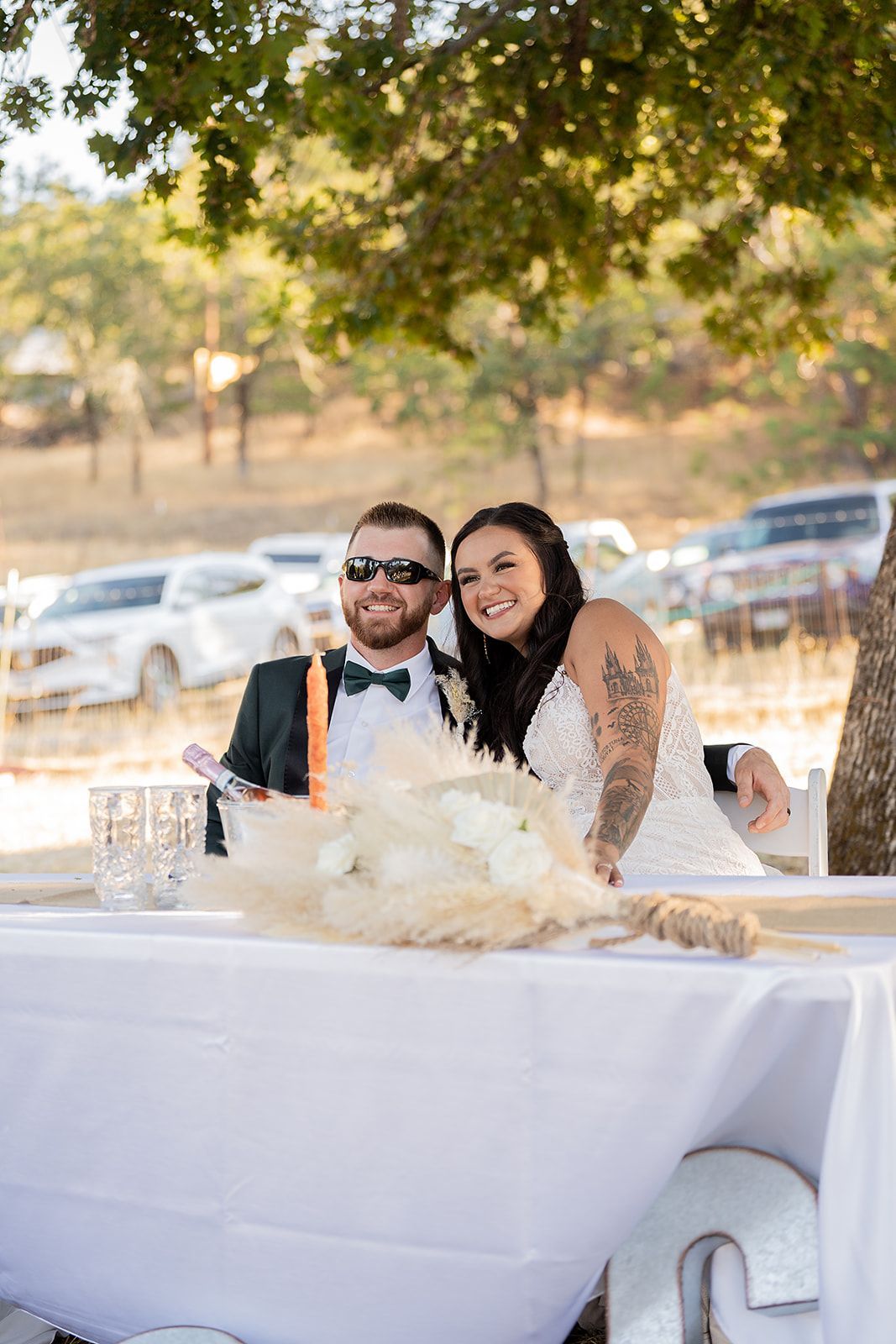 A bride and groom are posing for a picture in a bathtub.