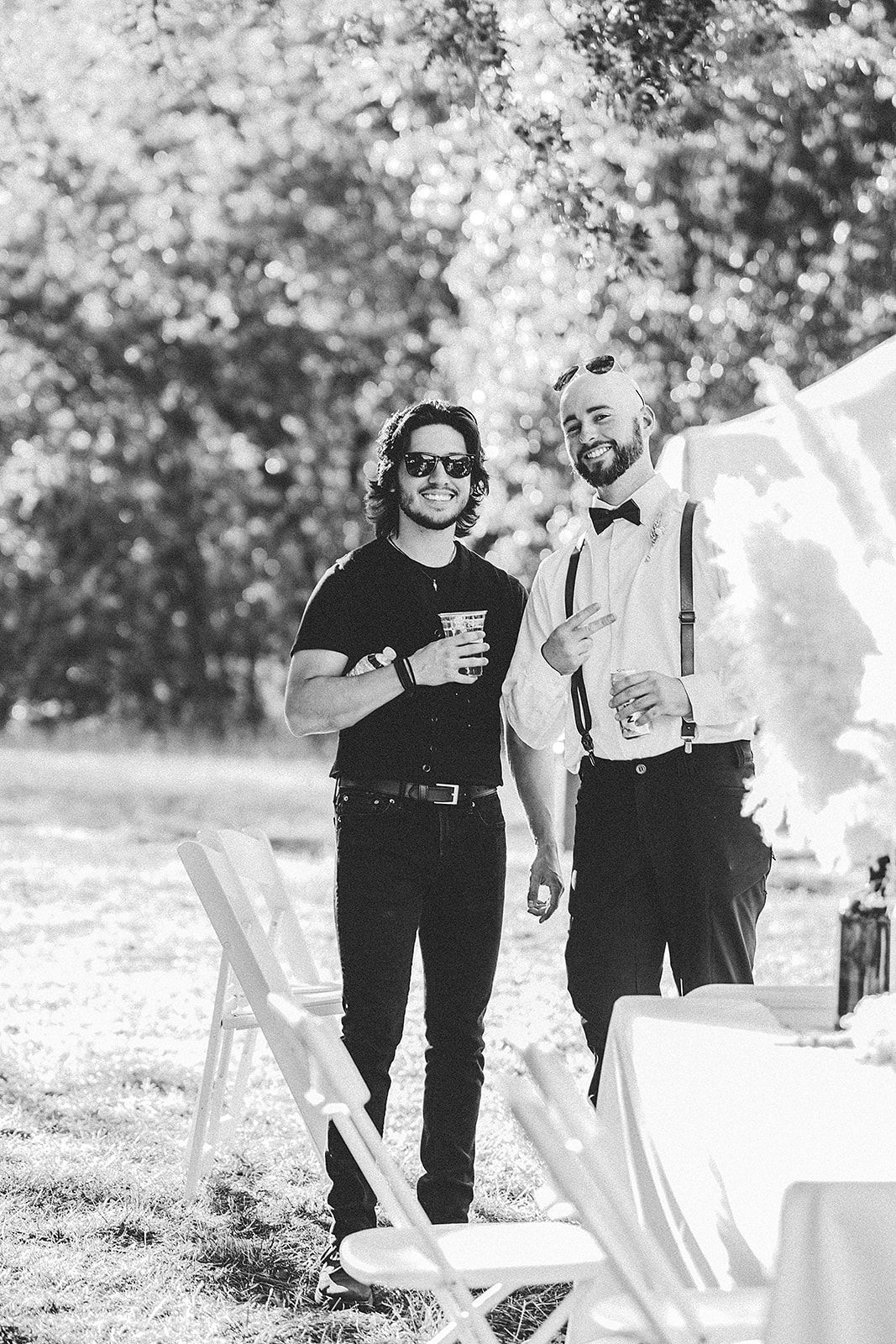 Two men are standing next to each other in a black and white photo.