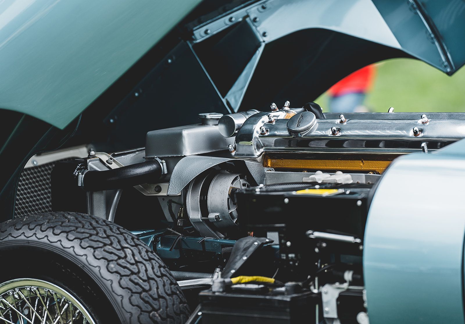 A close up of a car engine with the hood open