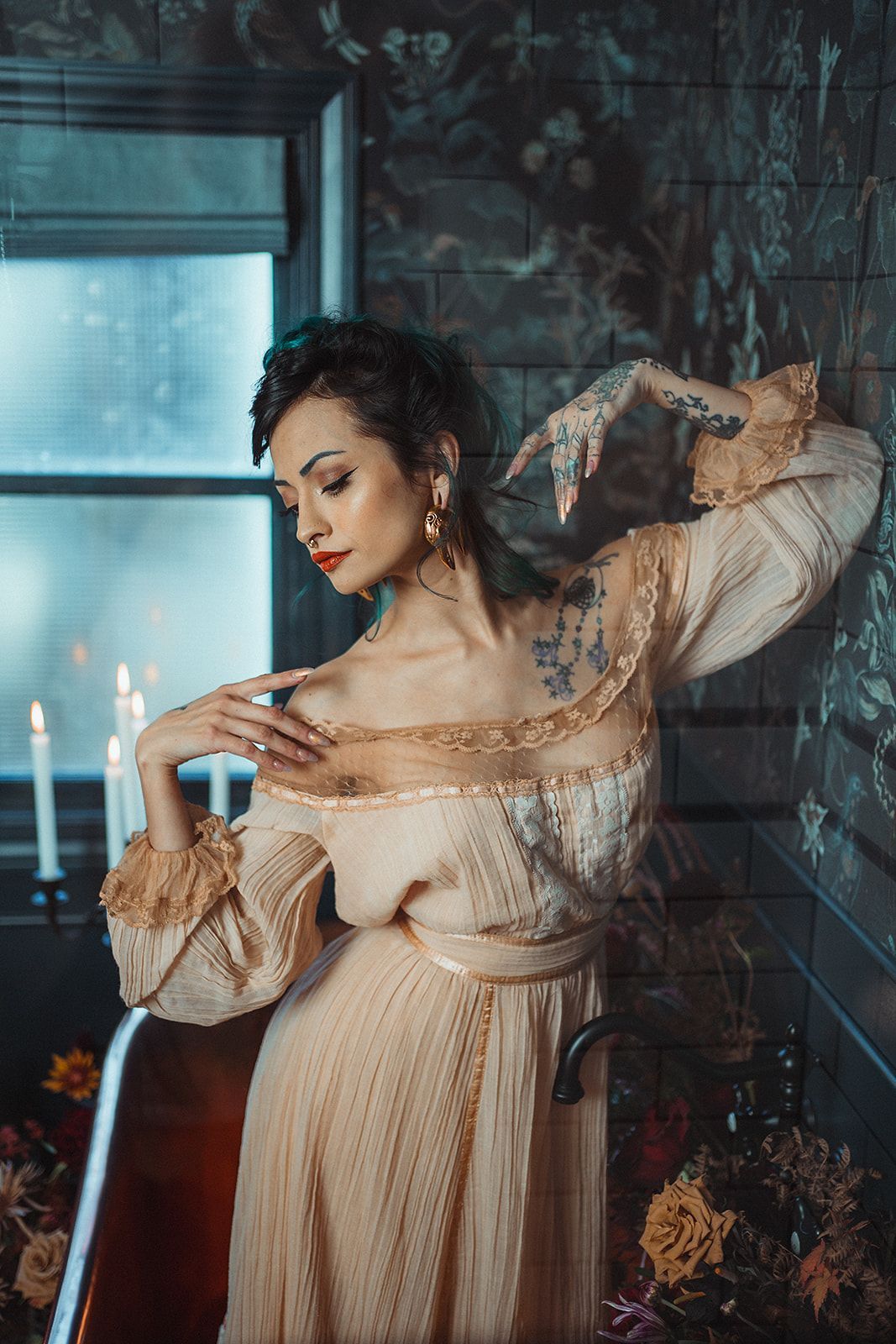 A woman in a dress is standing in a bathtub with candles.