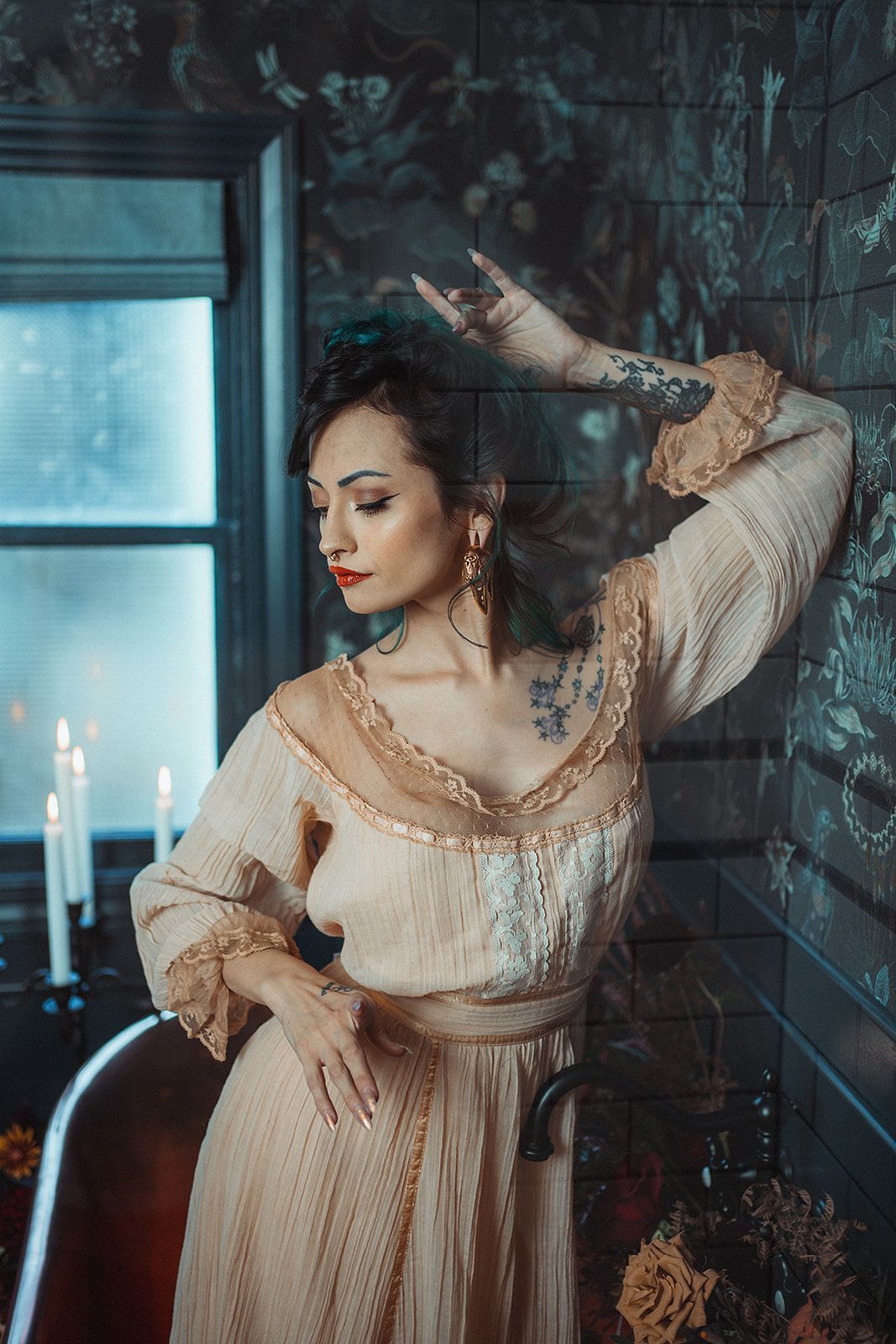 A woman in a dress is standing in a bathtub with candles.