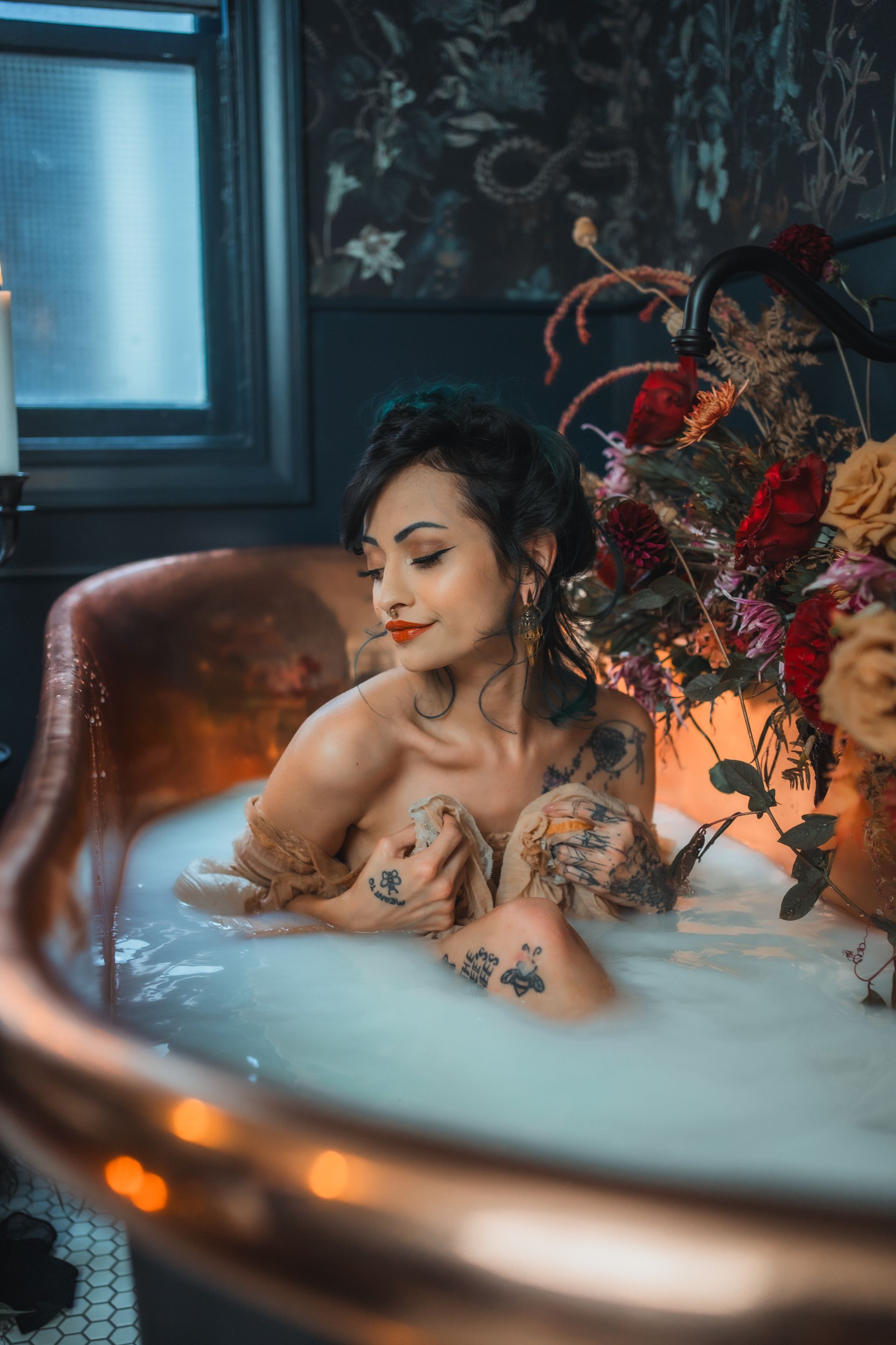 A woman is taking a bath in a bathtub filled with foam.