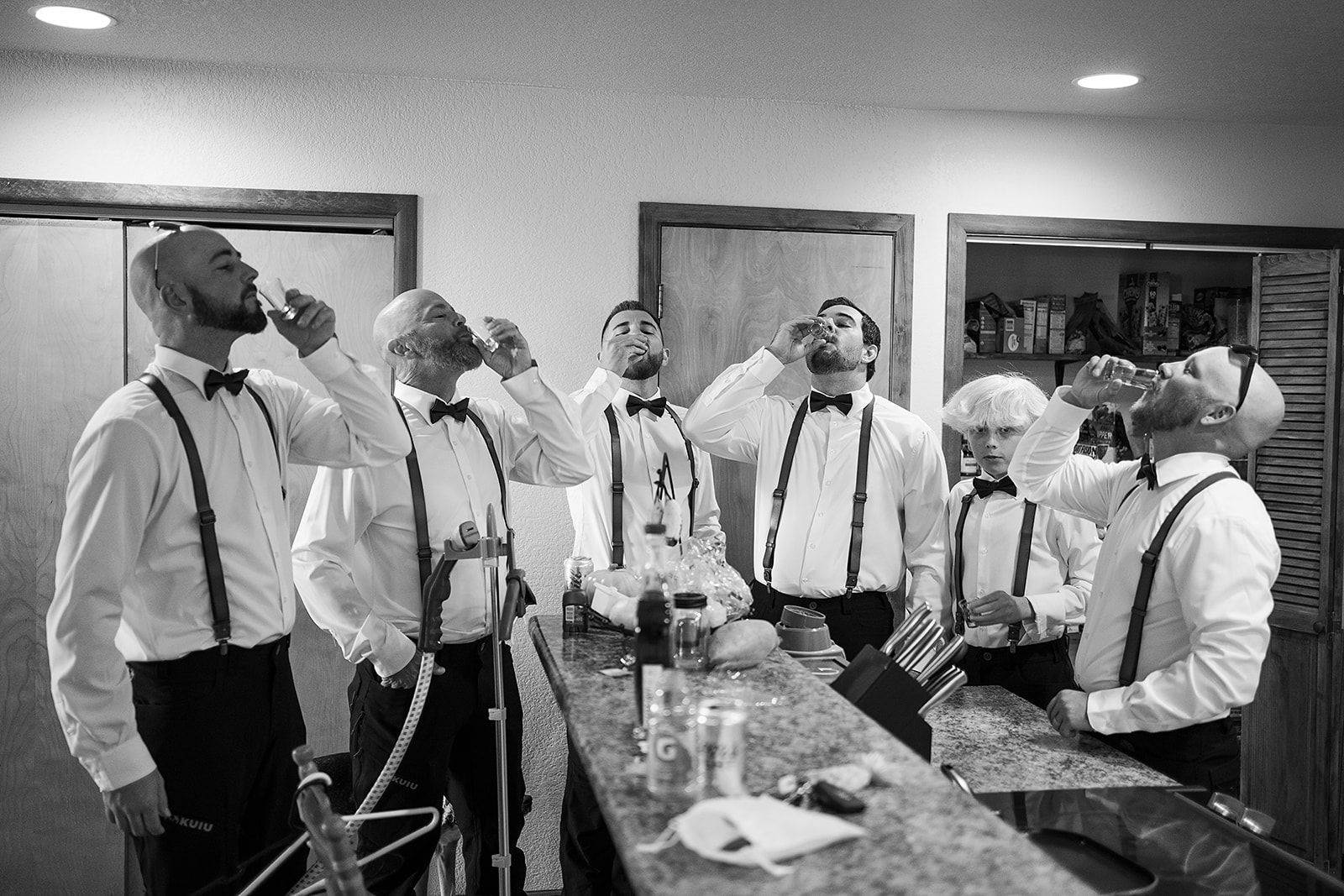 A black and white photo of a group of men drinking beer.