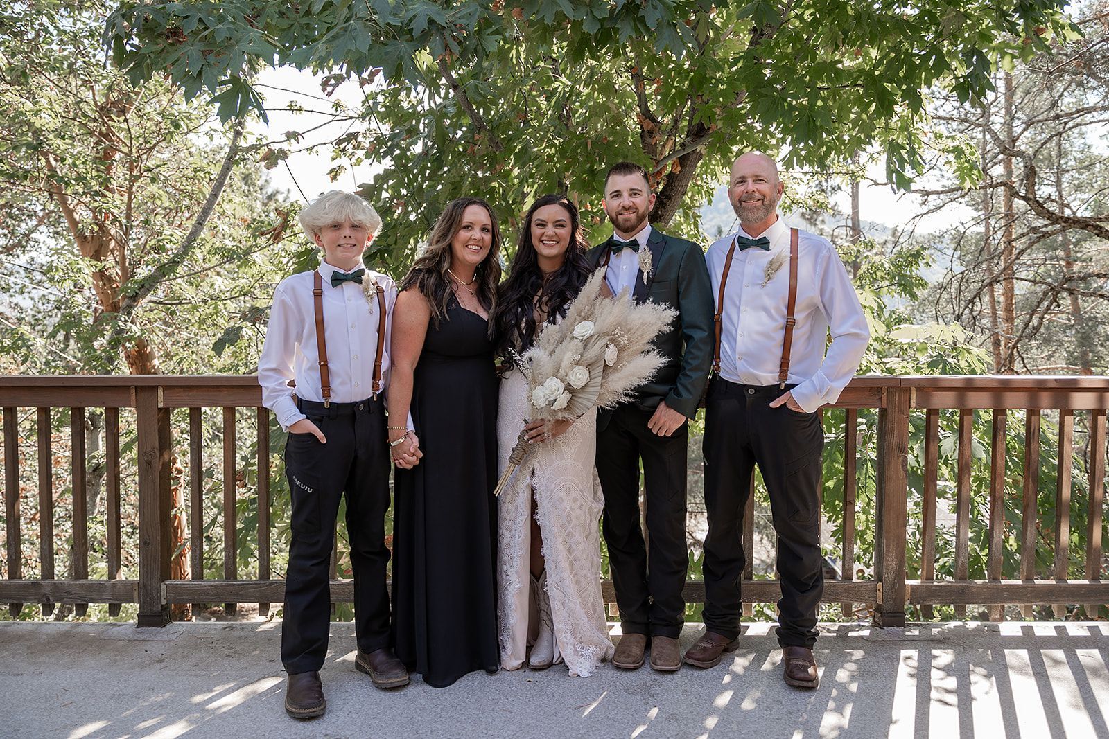 The bride and groom are posing for a picture with their wedding party.