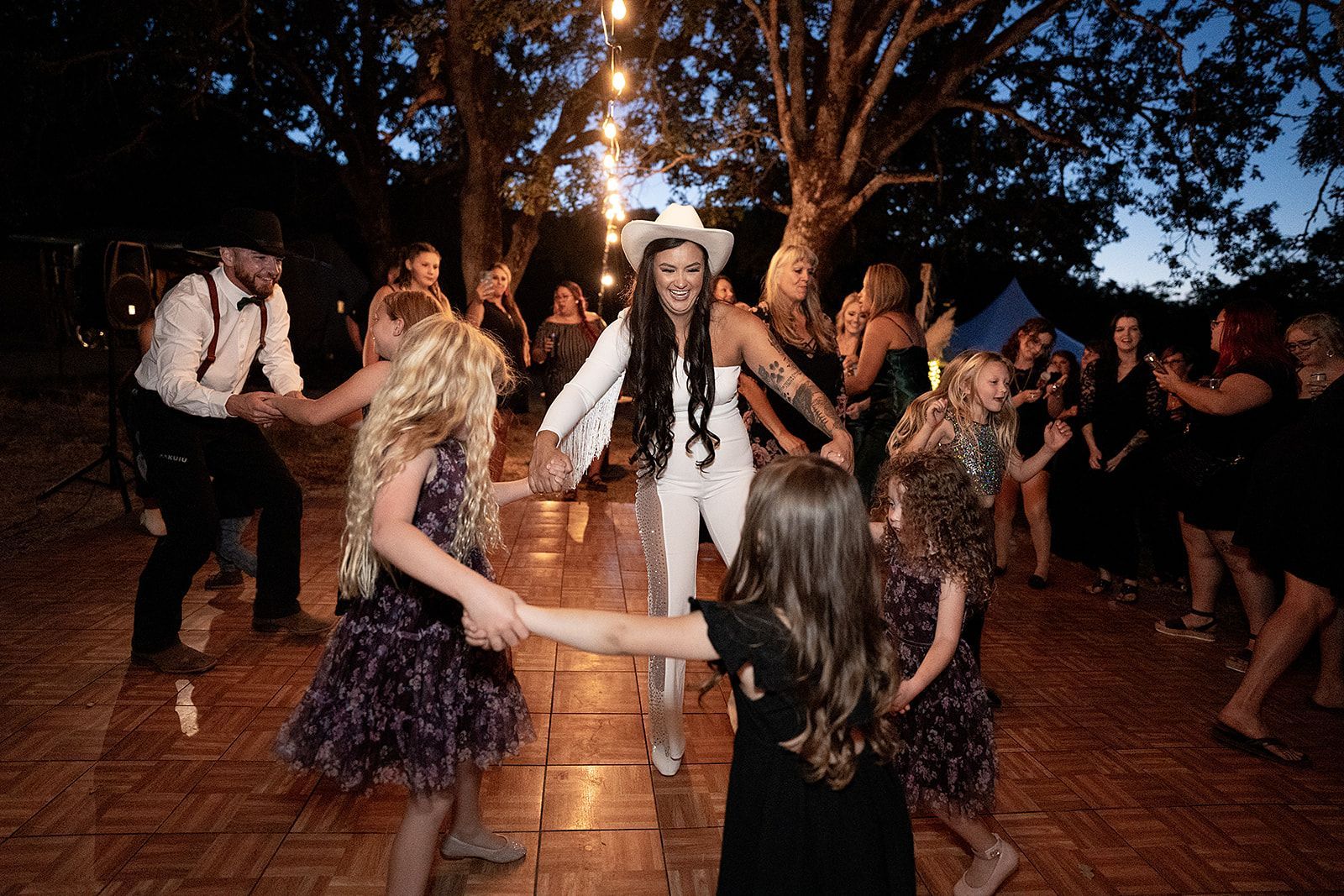 A group of people are dancing in a circle on a dance floor.