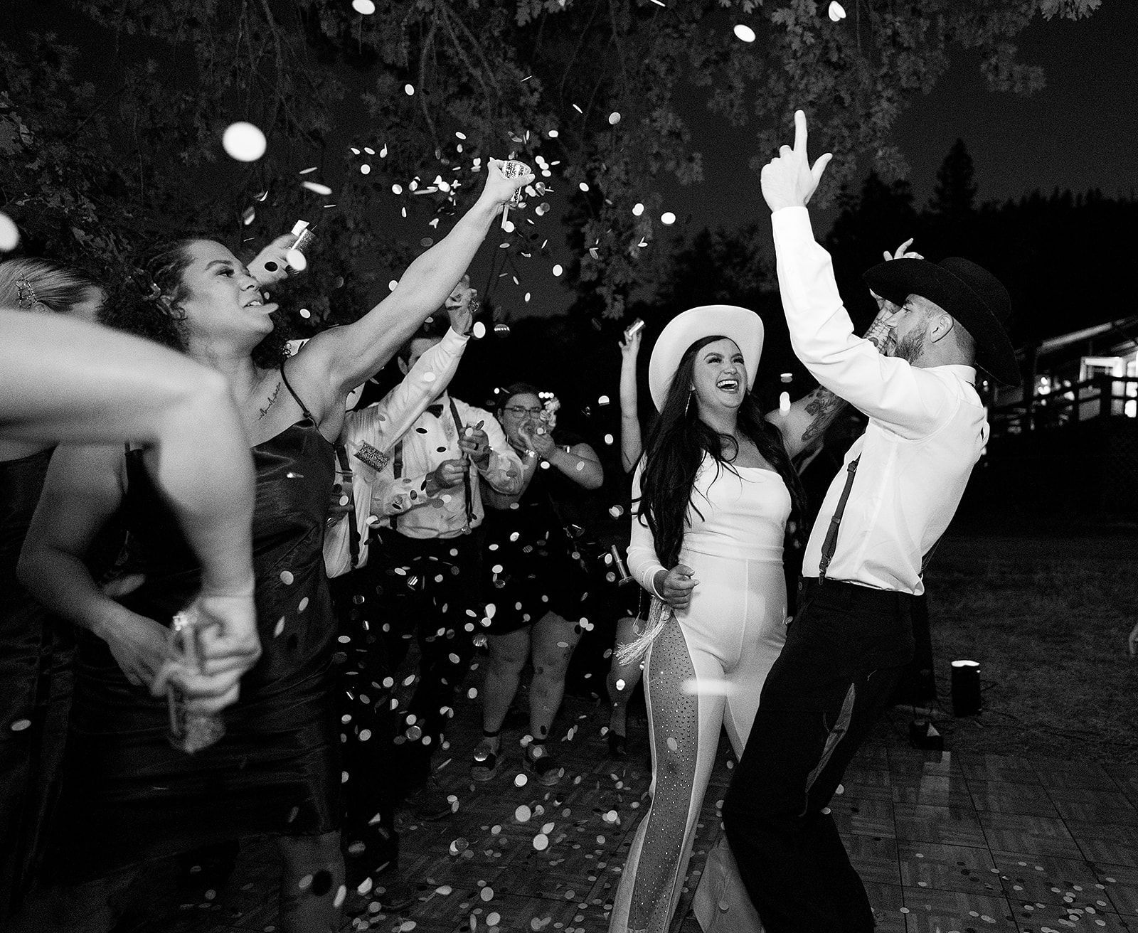 A black and white photo of a bride and groom dancing at a wedding reception.