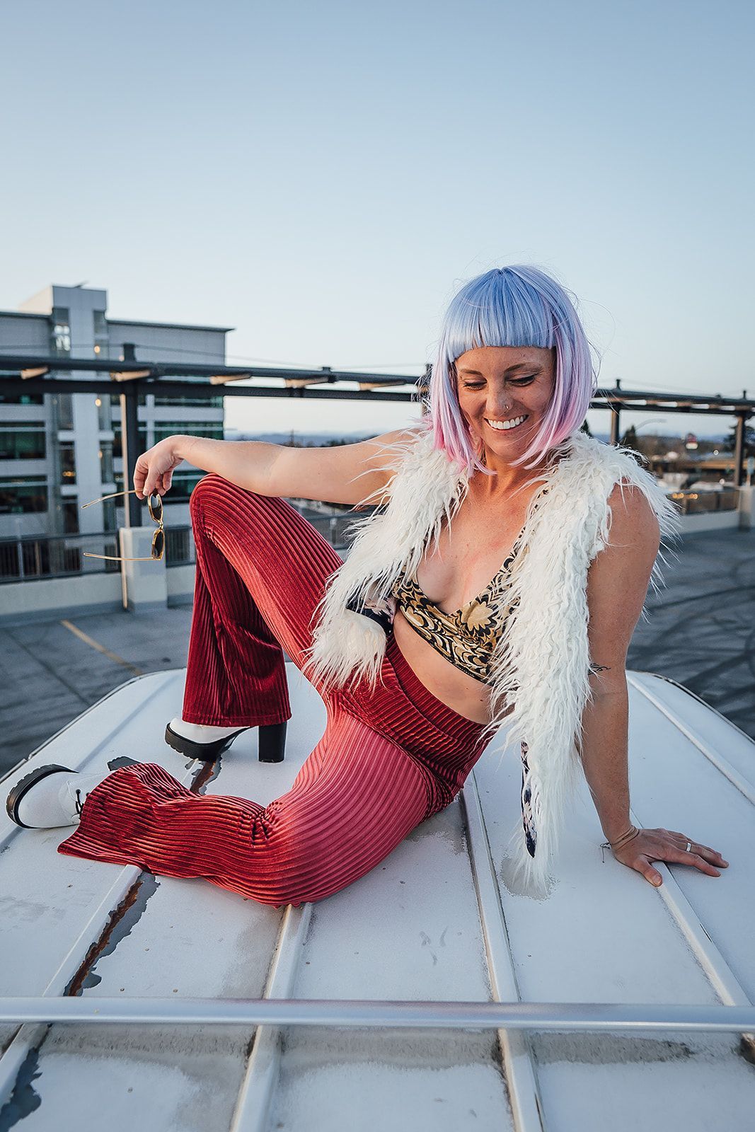 A woman is sitting on top of a white boat.