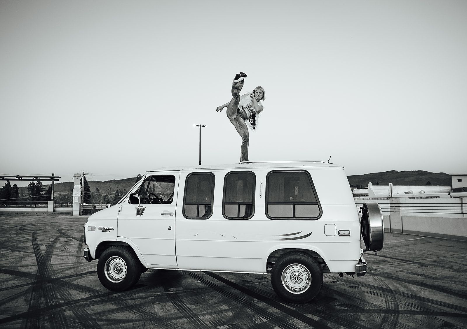 A man is standing on top of a white van