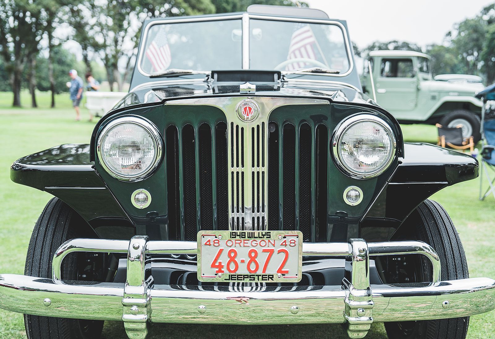 A black jeep with a license plate that says 48-872