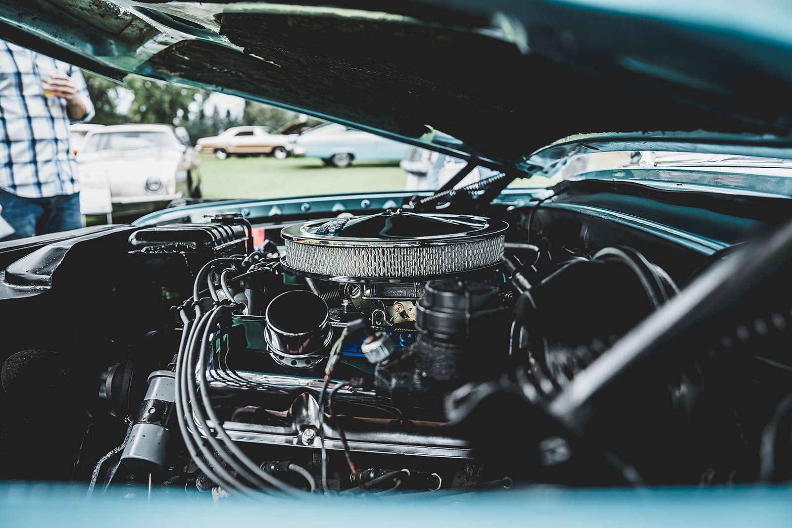 A close up of a car engine with the hood open.