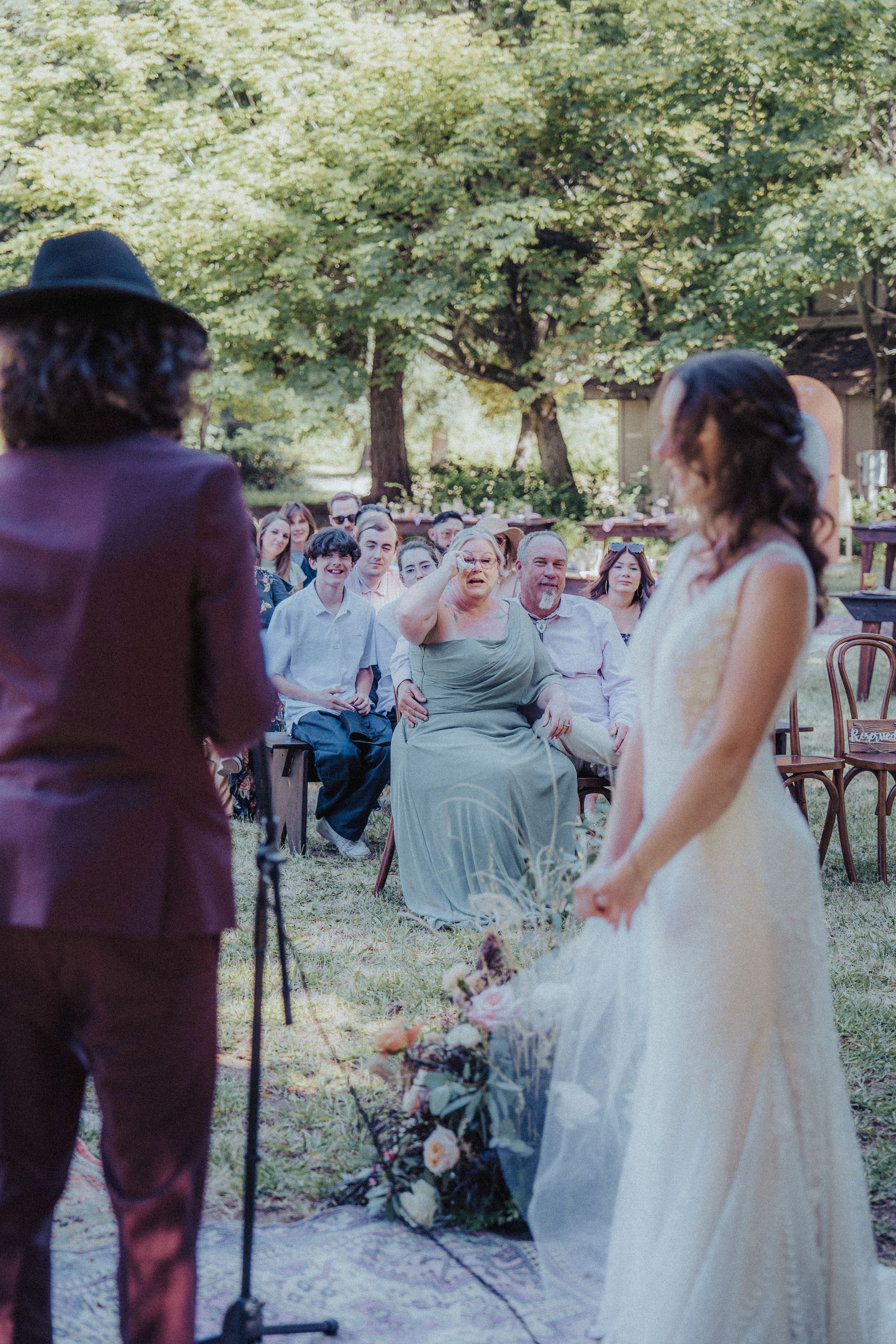 A bride and groom are standing in front of a microphone at their wedding ceremony.