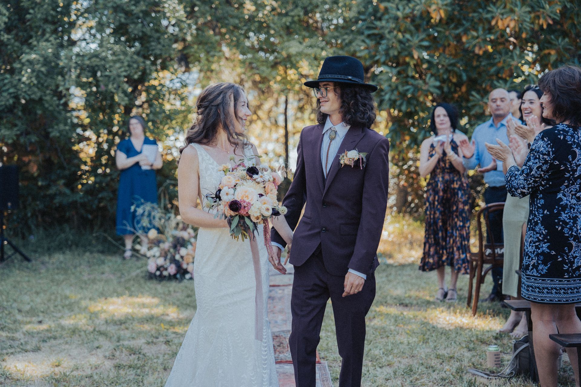 A bride and groom are walking down the aisle at their wedding.