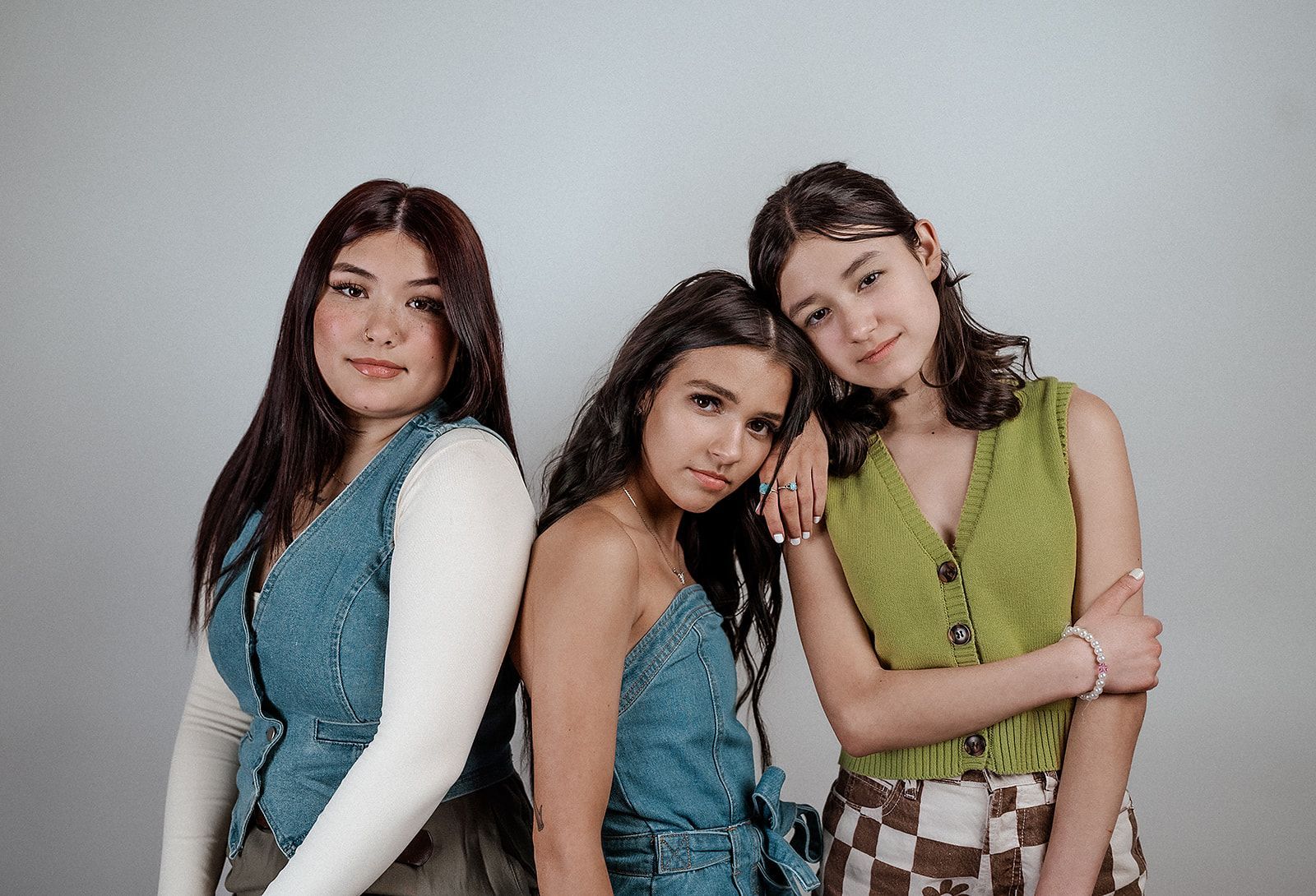 Three young women are posing for a picture together.