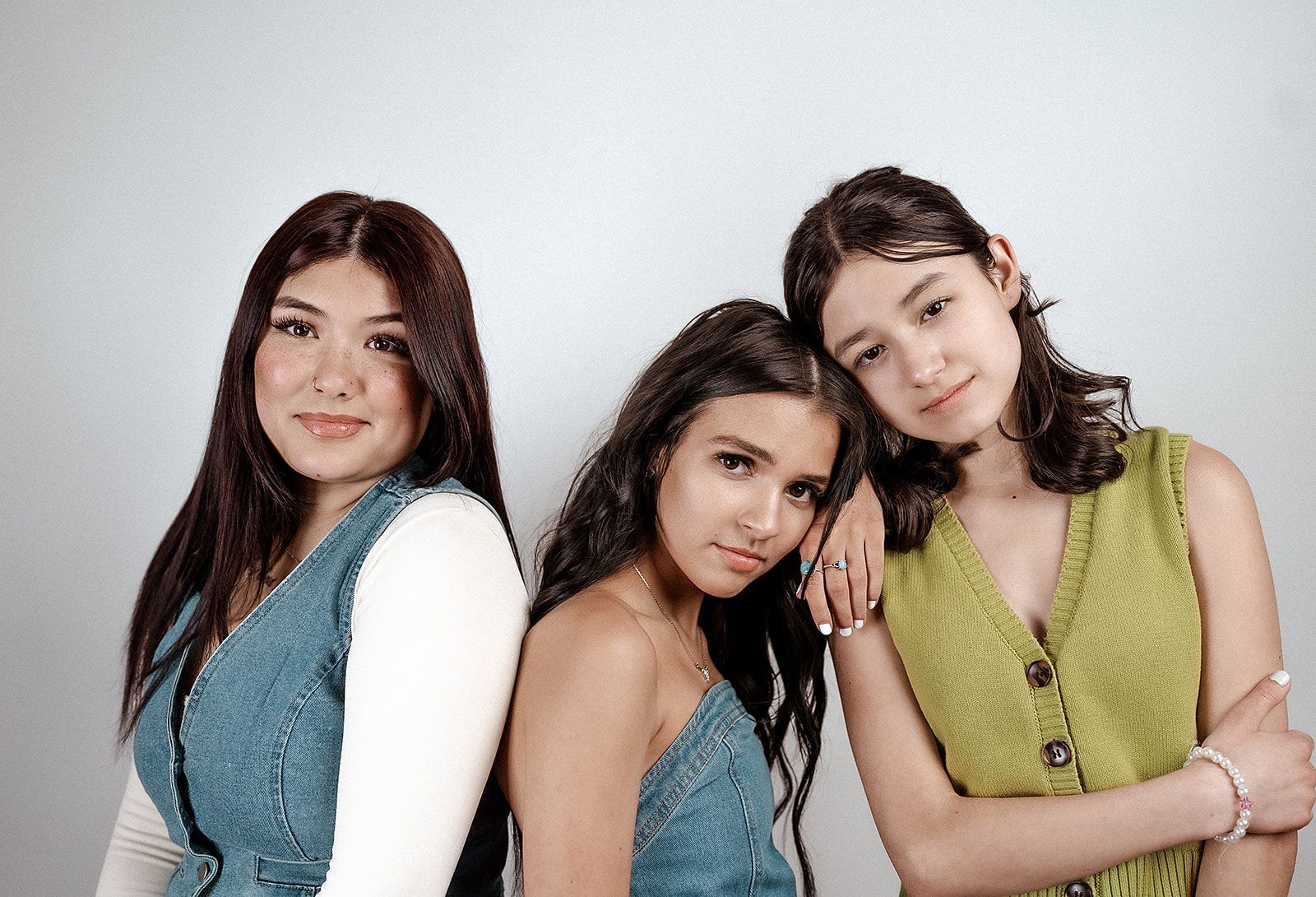 Three young women are posing for a picture together.