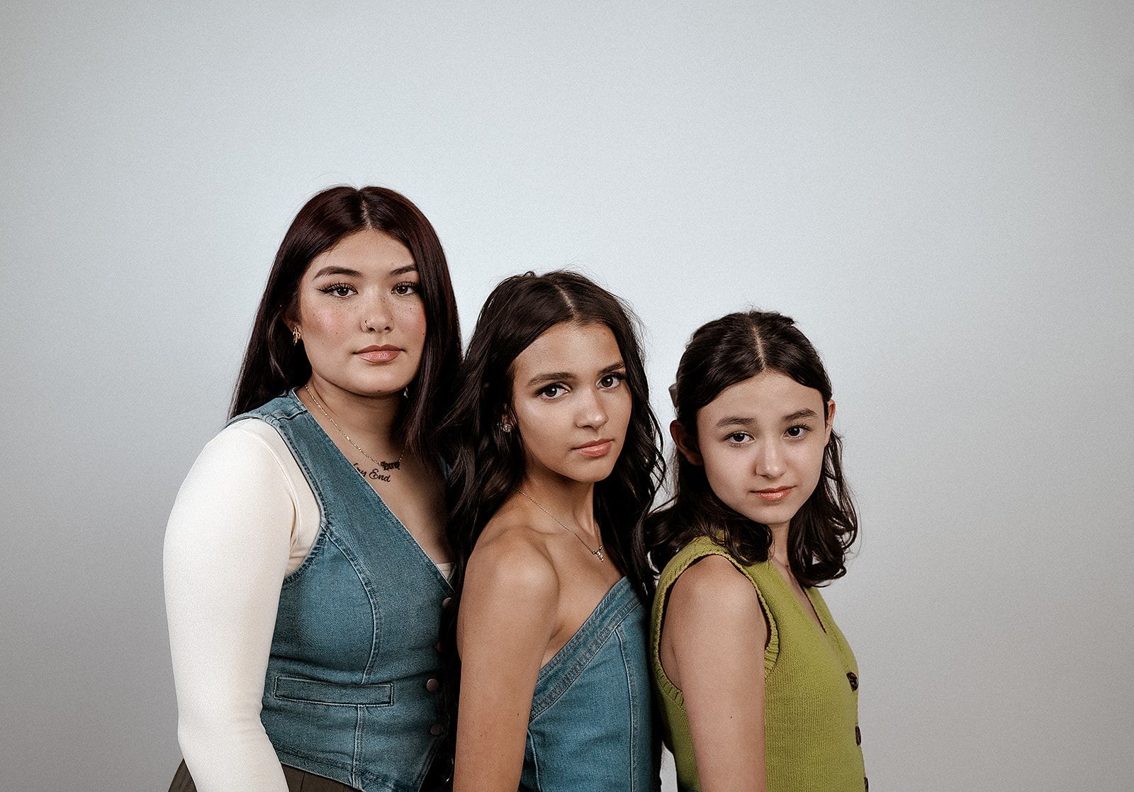 Three young women are posing for a picture together.