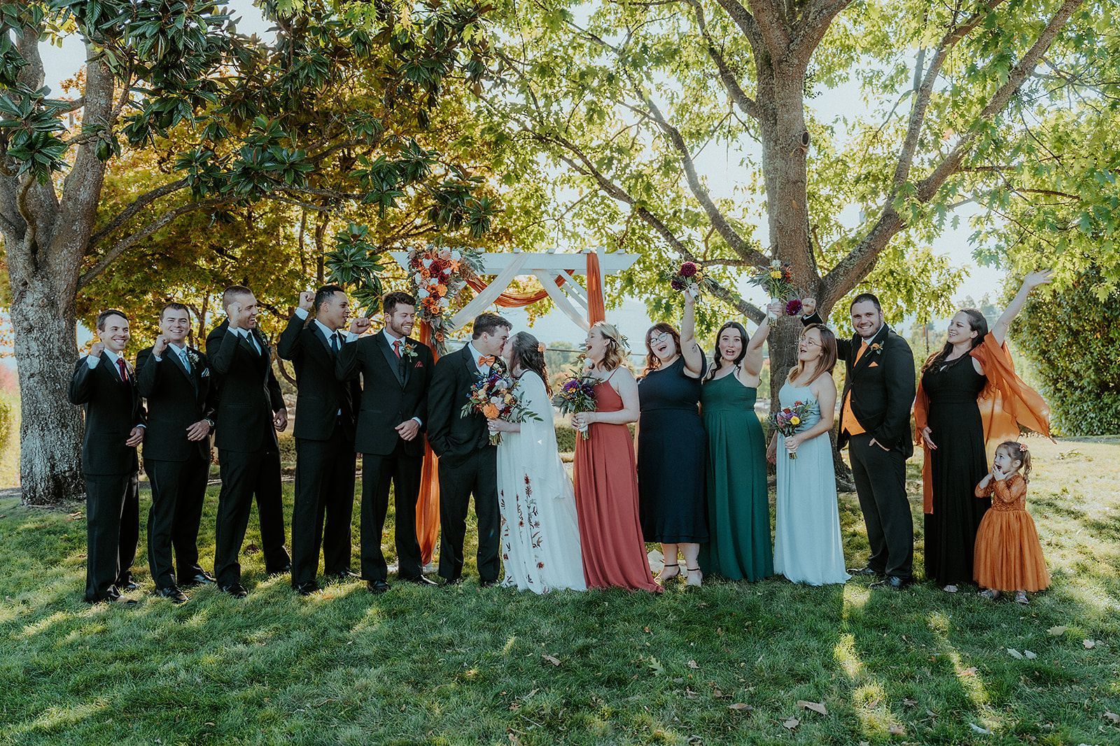 A wedding party is posing for a picture at a wedding.