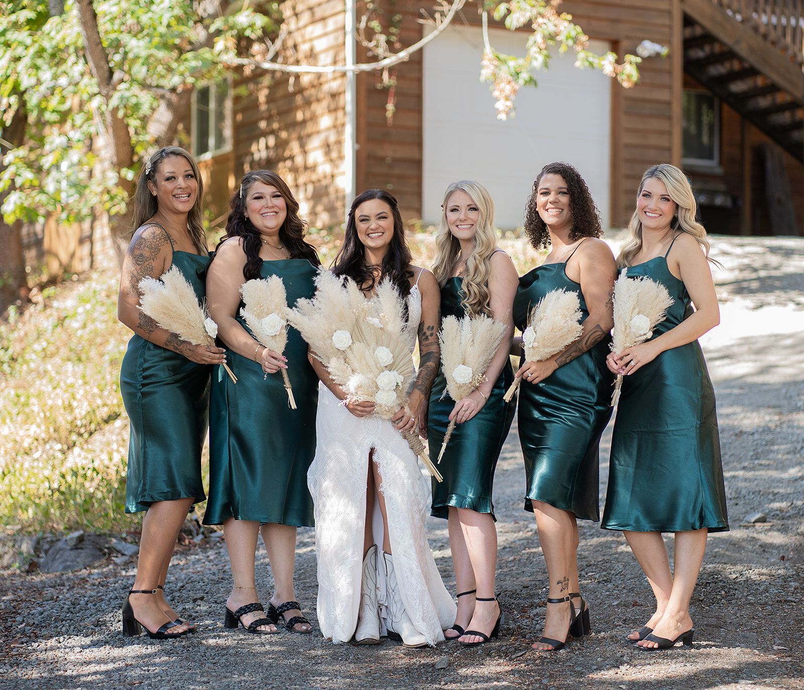 A bride and her bridesmaids are posing for a picture.