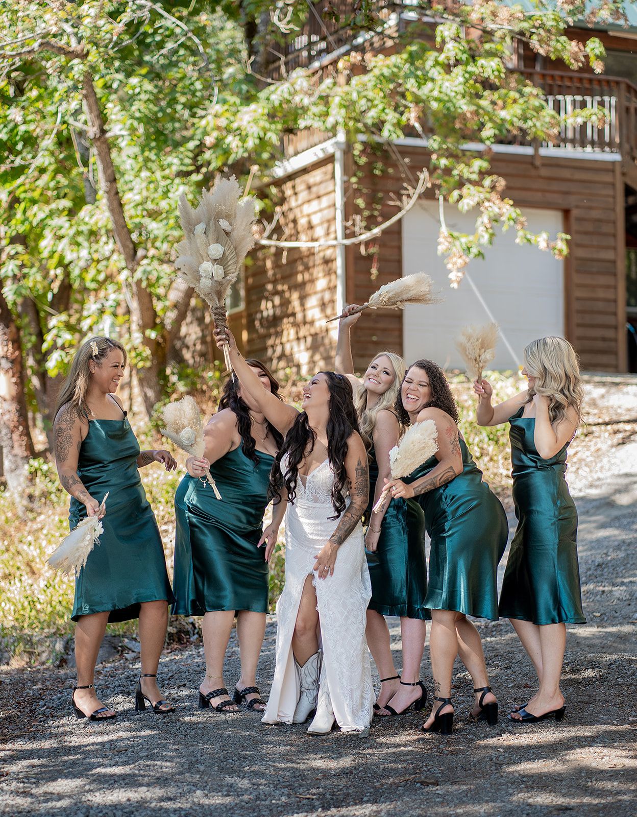 A bride and her bridesmaids are posing for a picture.
