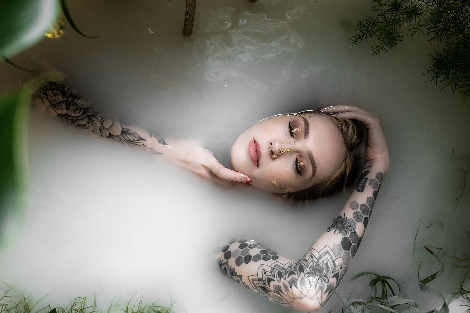 A woman is laying in a bathtub filled with foam.