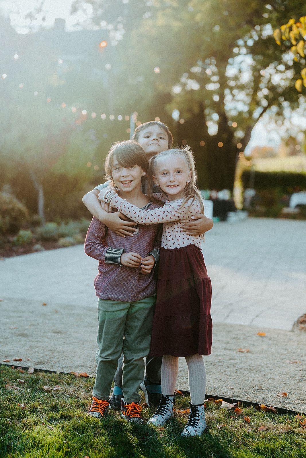 Three children are hugging each other at a wedding in Southern Oregon.