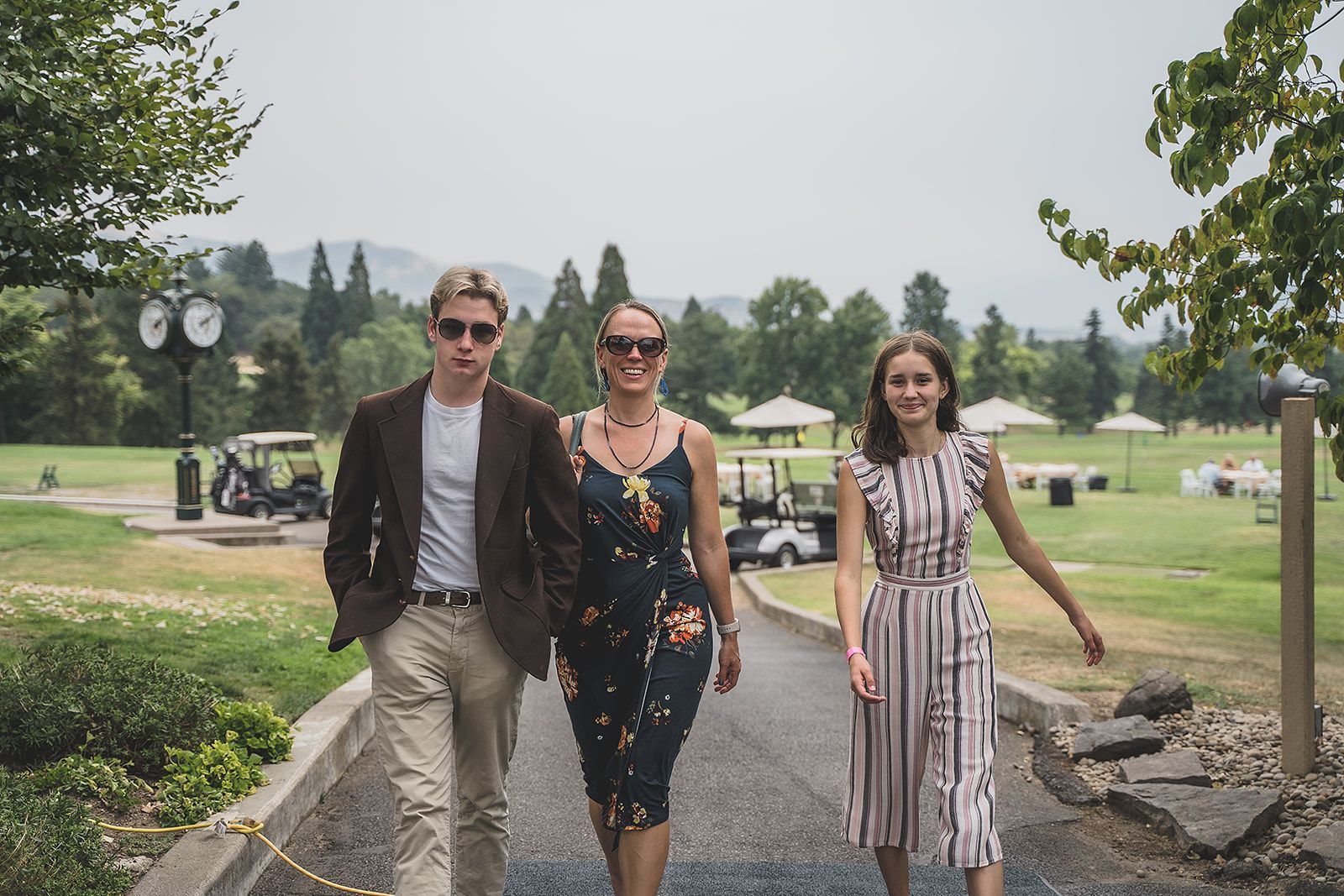 A group of people are walking down a path in a park.