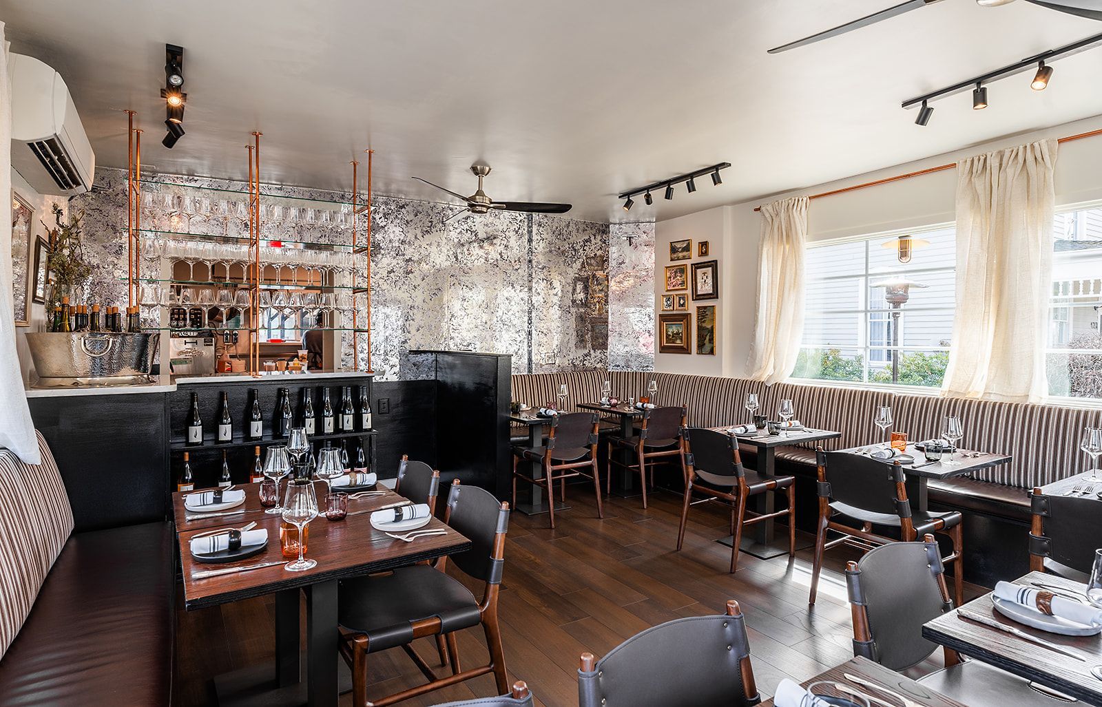 A large dining room with tables and chairs in a restaurant.