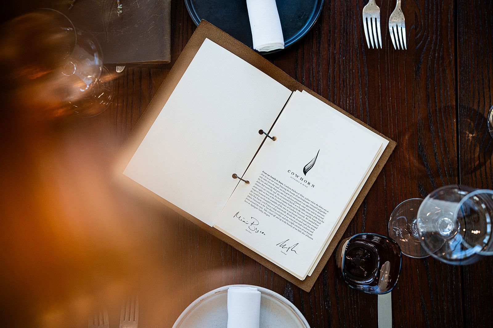 A menu is sitting on top of a wooden table.