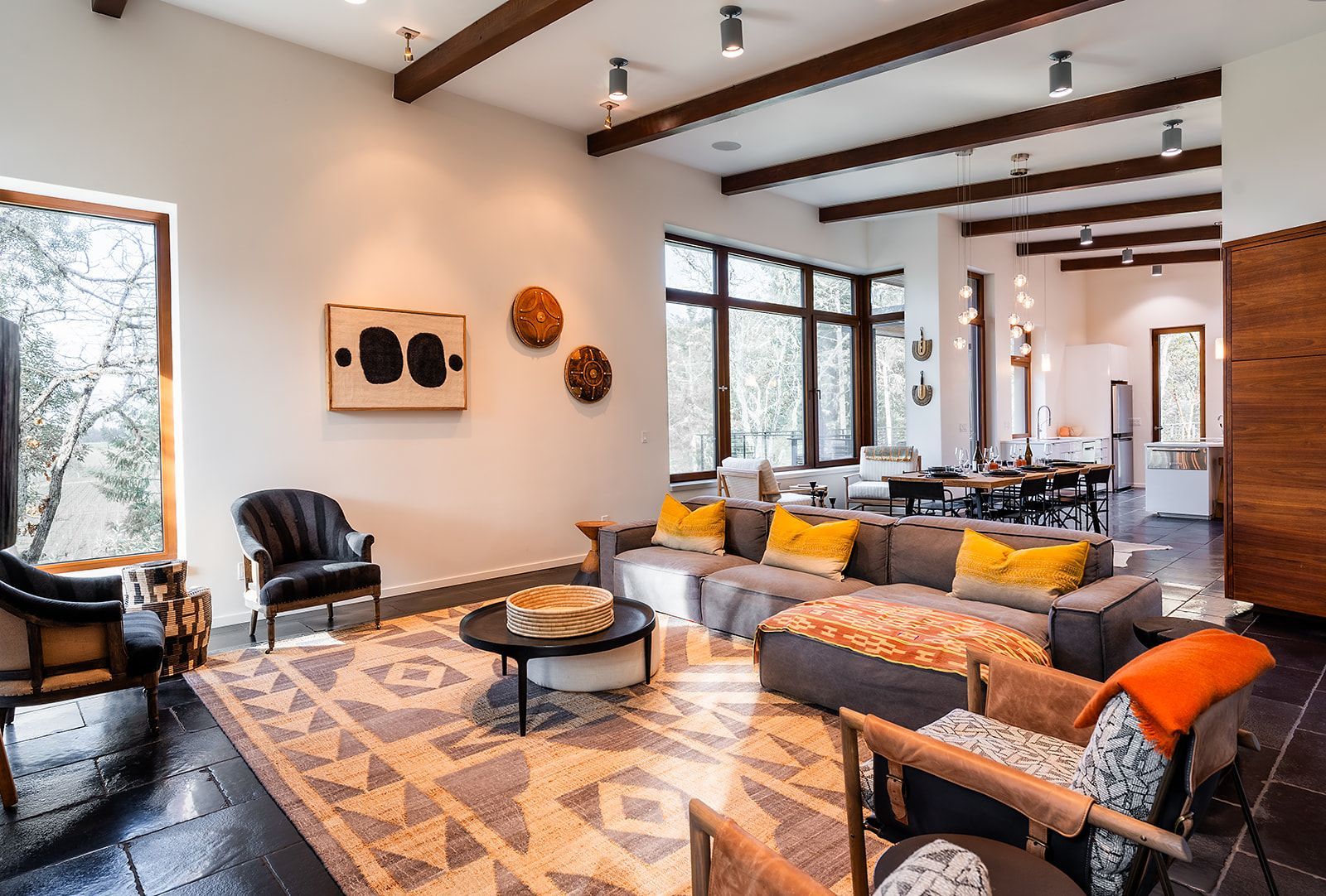 A living room filled with furniture and a rug.