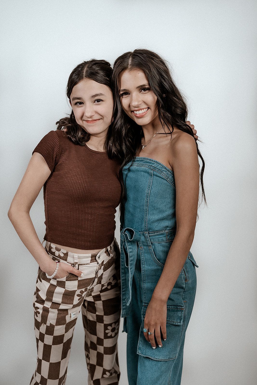 Two young women are posing for a picture together.
