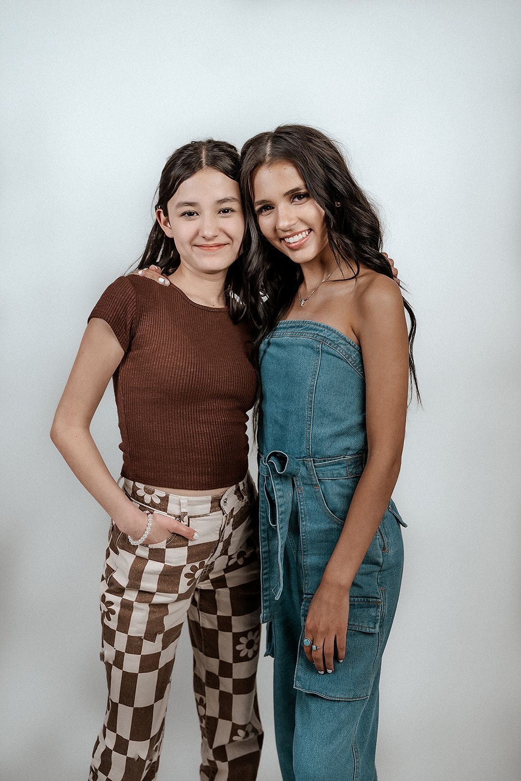 Two young women are posing for a picture together.