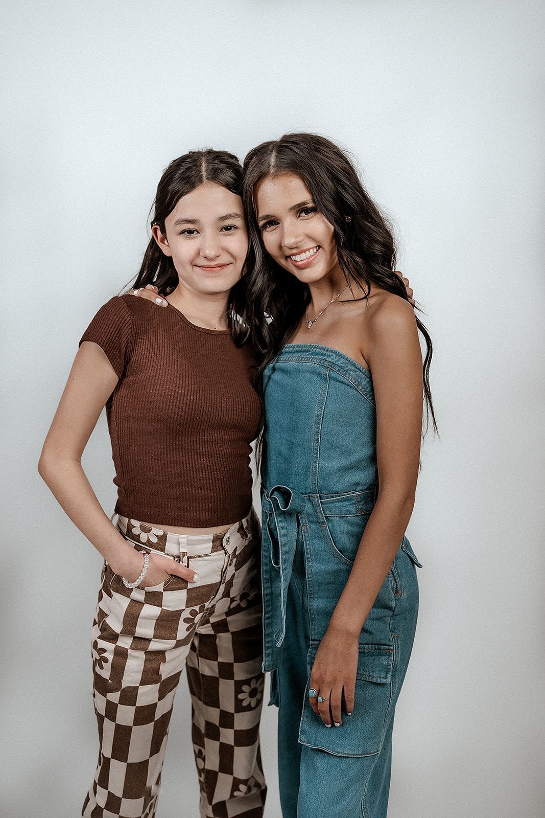 Two young women are posing for a picture together.