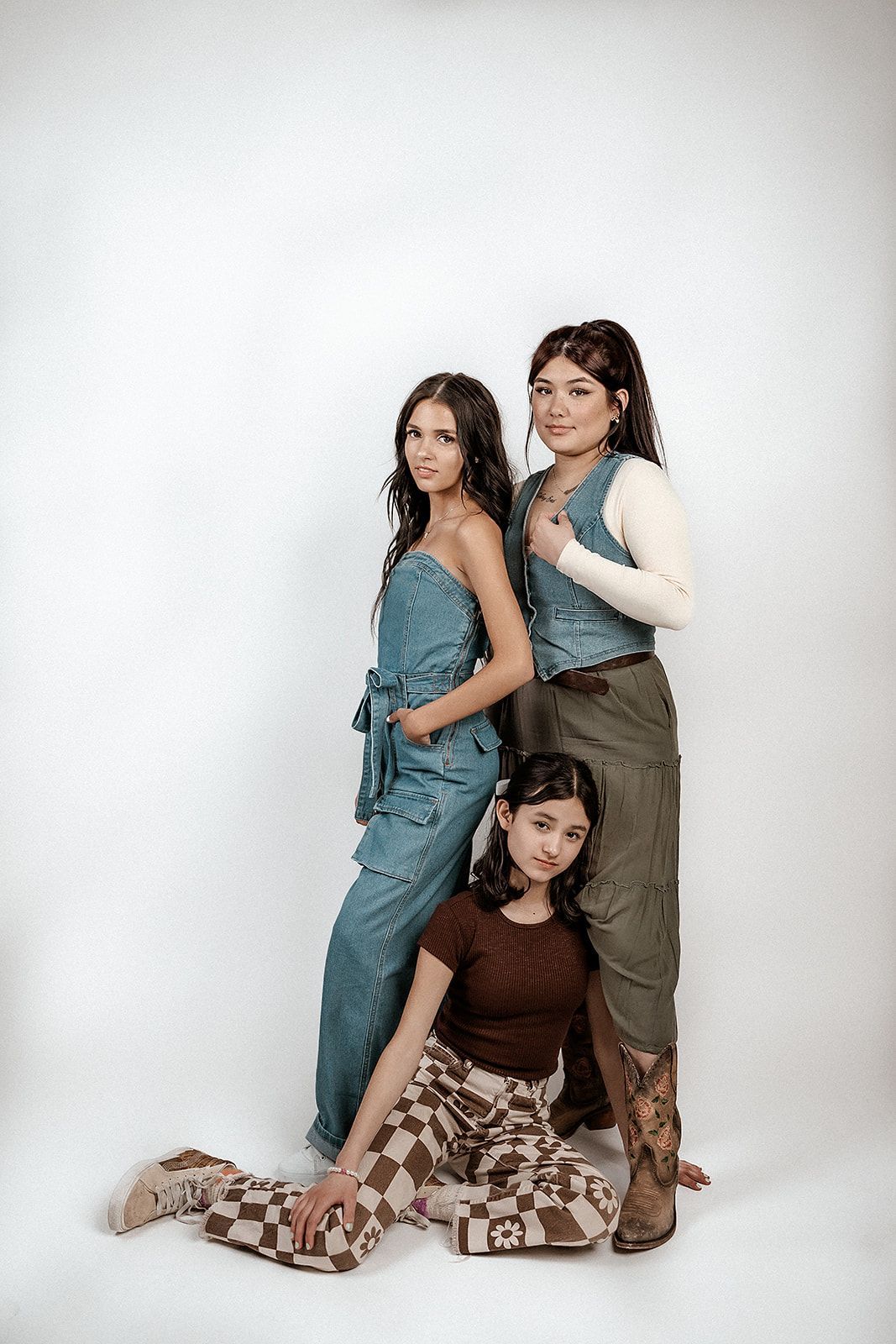 Three young women are posing for a picture together.