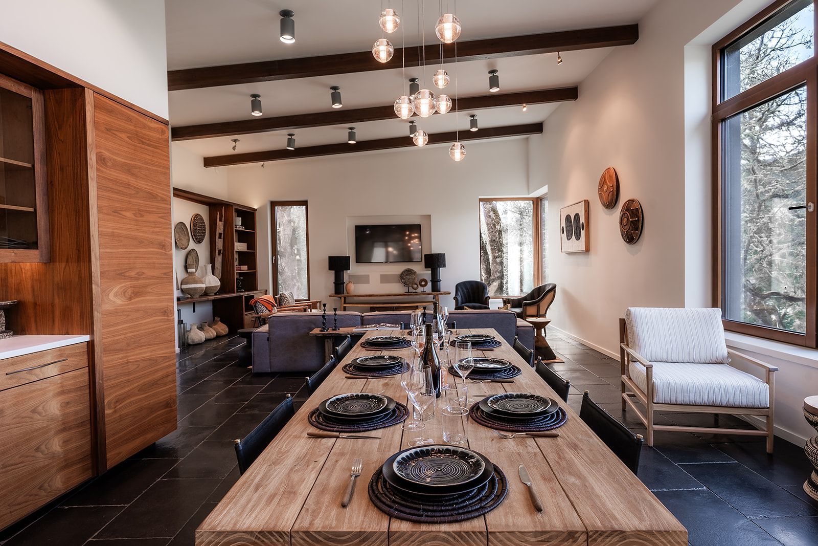 There is a long wooden table in the middle of the room.