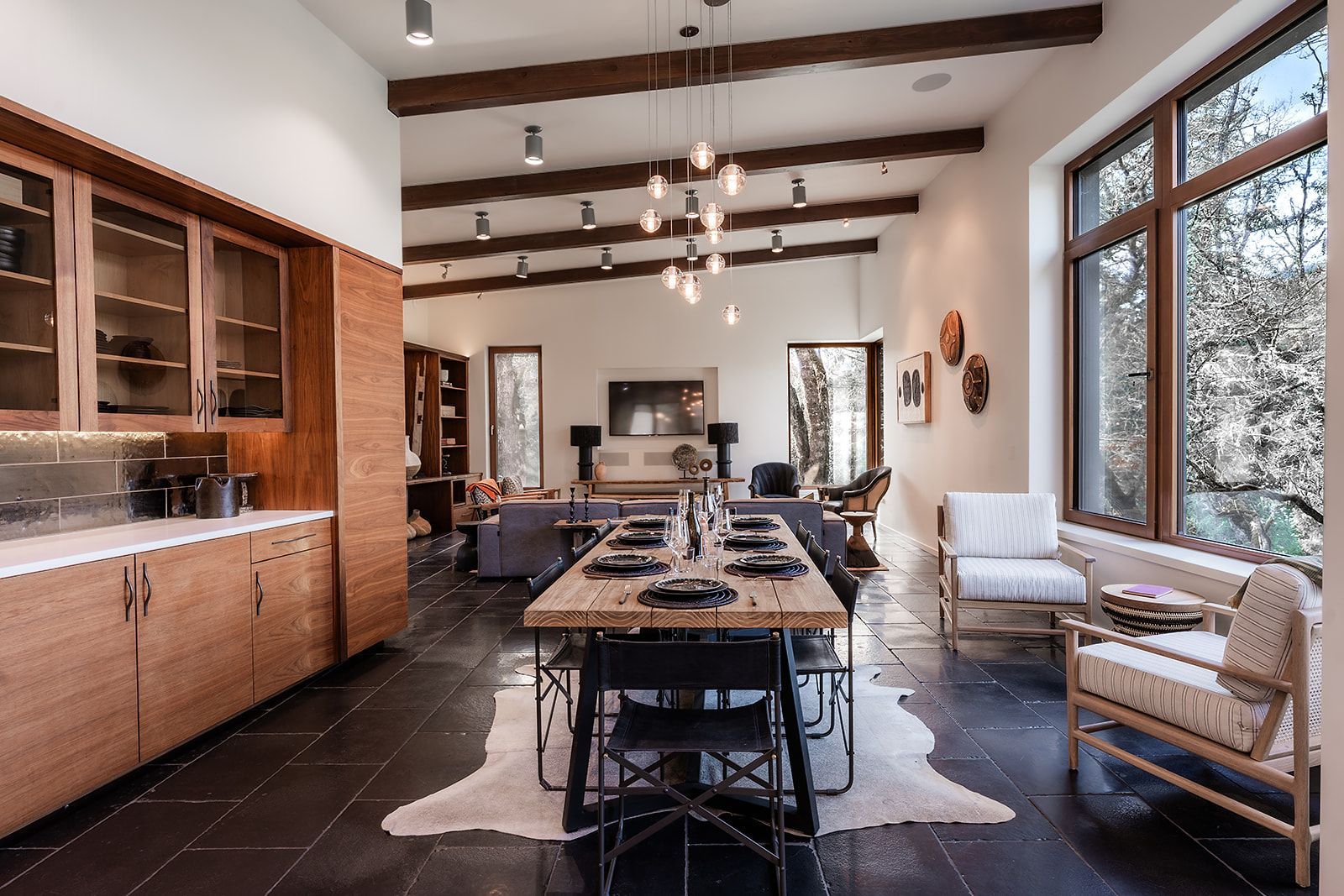 A kitchen with a dining table and chairs in it