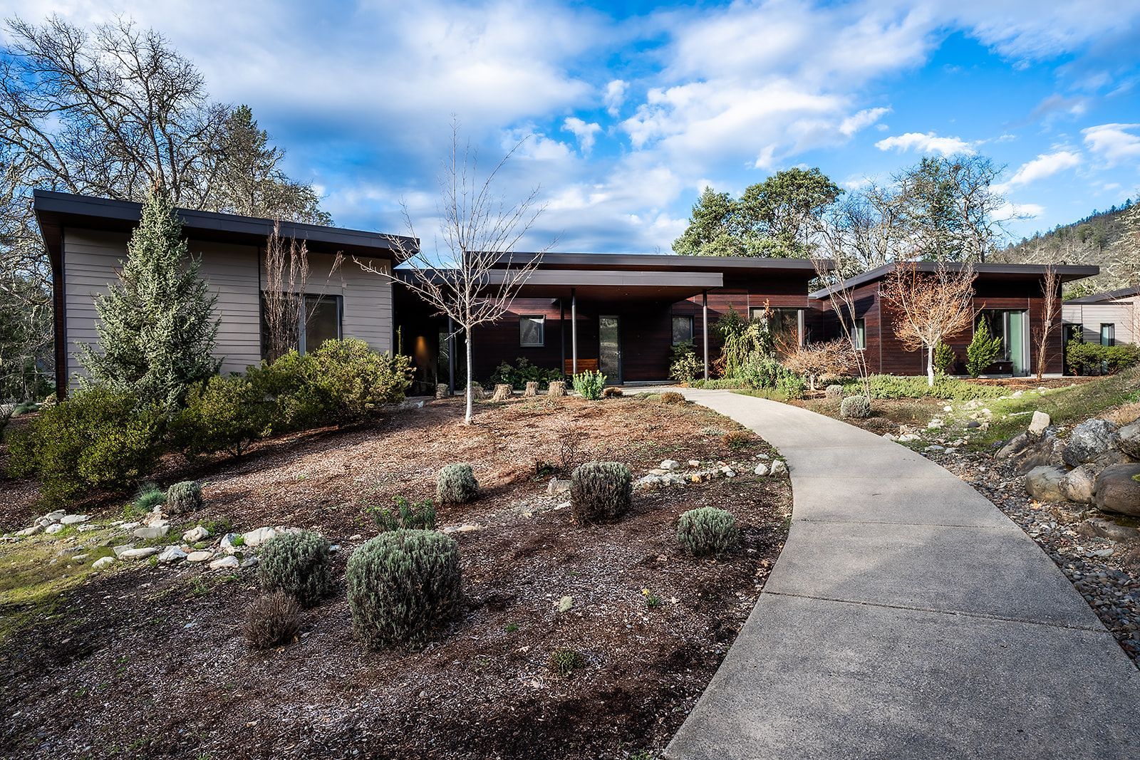 There is a walkway leading to the front of the house.