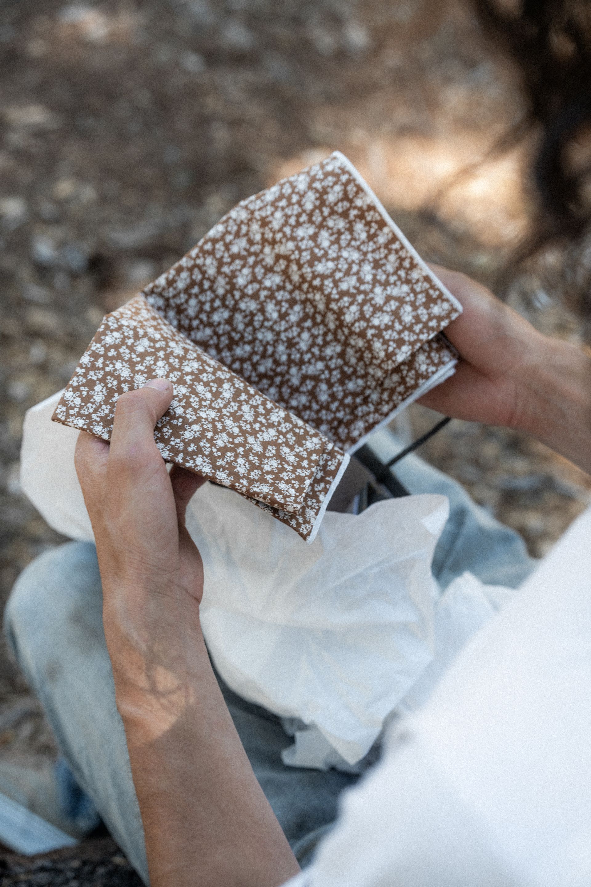 A person is holding a piece of fabric in their hands.