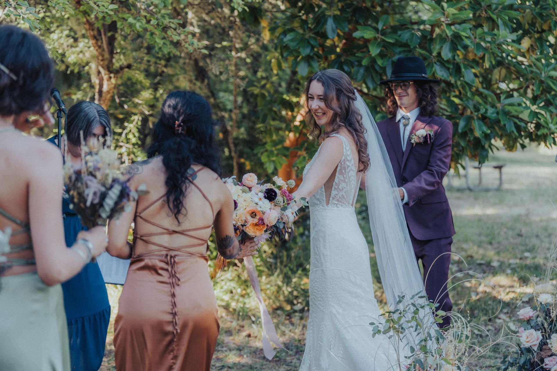A bride and groom are walking down the aisle with their wedding party.
