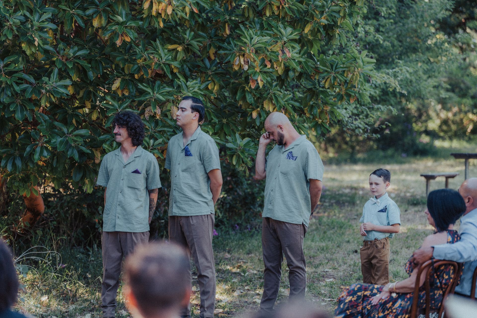 A group of men standing next to each other in a field.